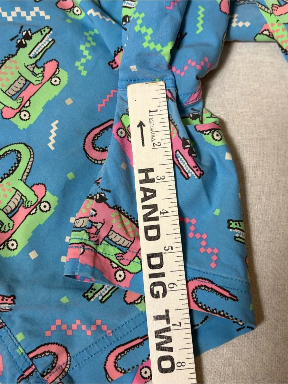 blue Party Pants swim trunks with an all-over neon alligator